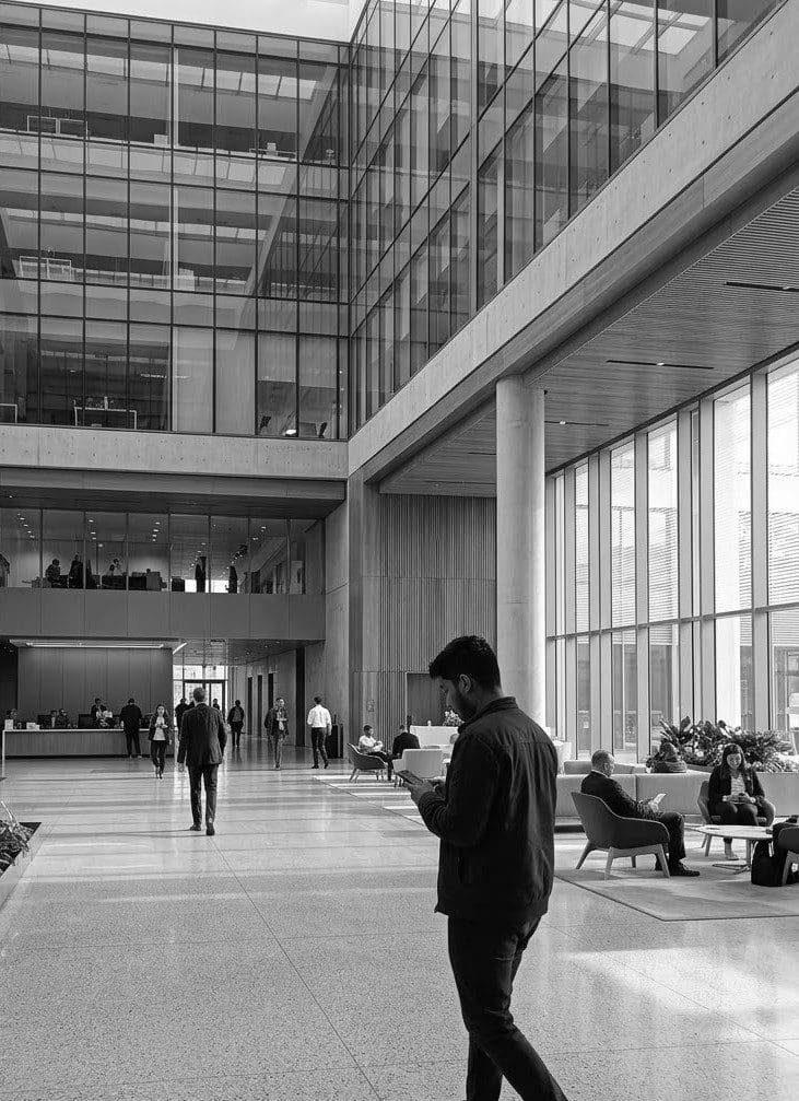 A professional walking through a modern office lobby