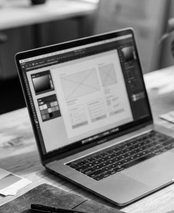 Design wireframes open on a laptop